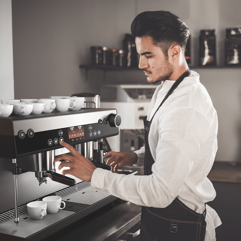 Barista using a WMF Espresso Coffee Machine