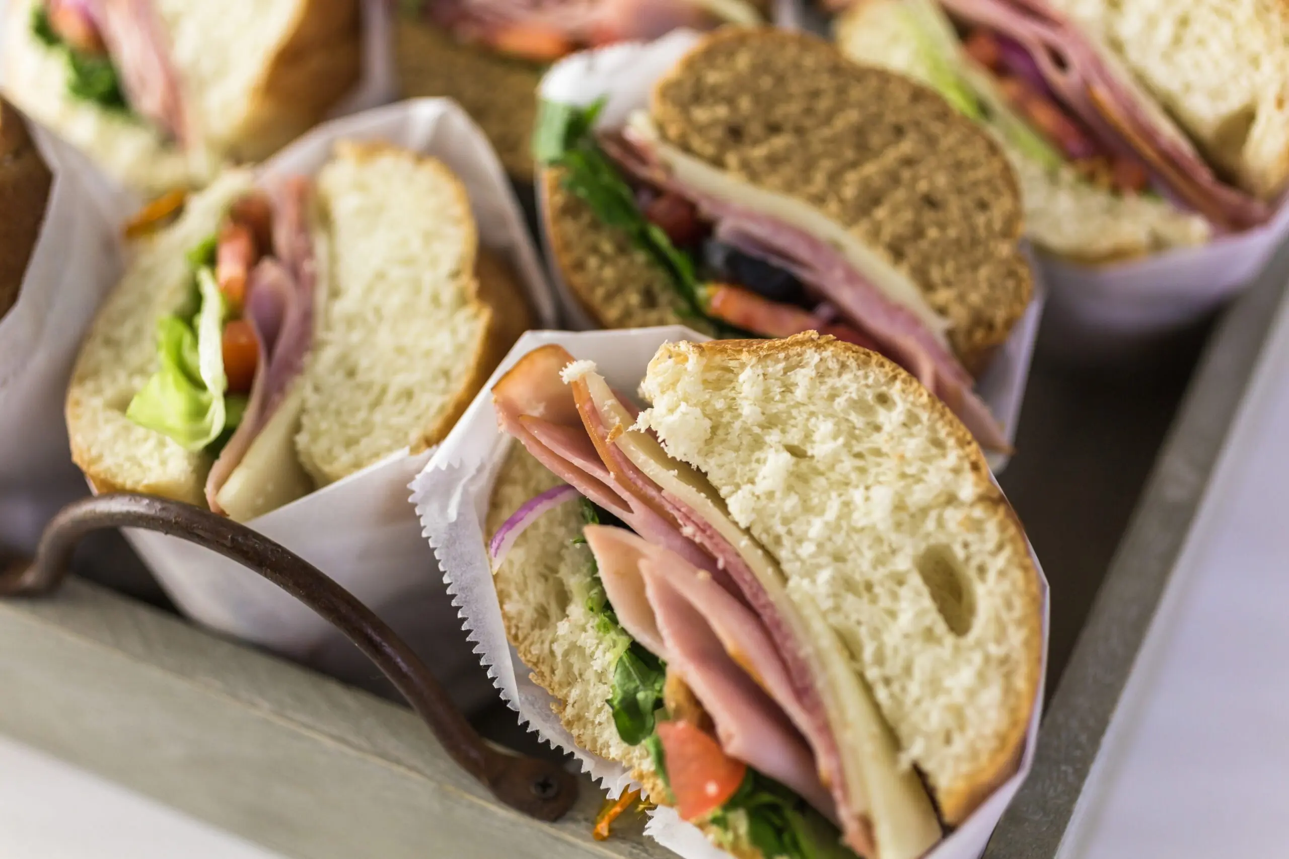 A selection of fresh sandwiches with ham, cheese, salad and tomatoes