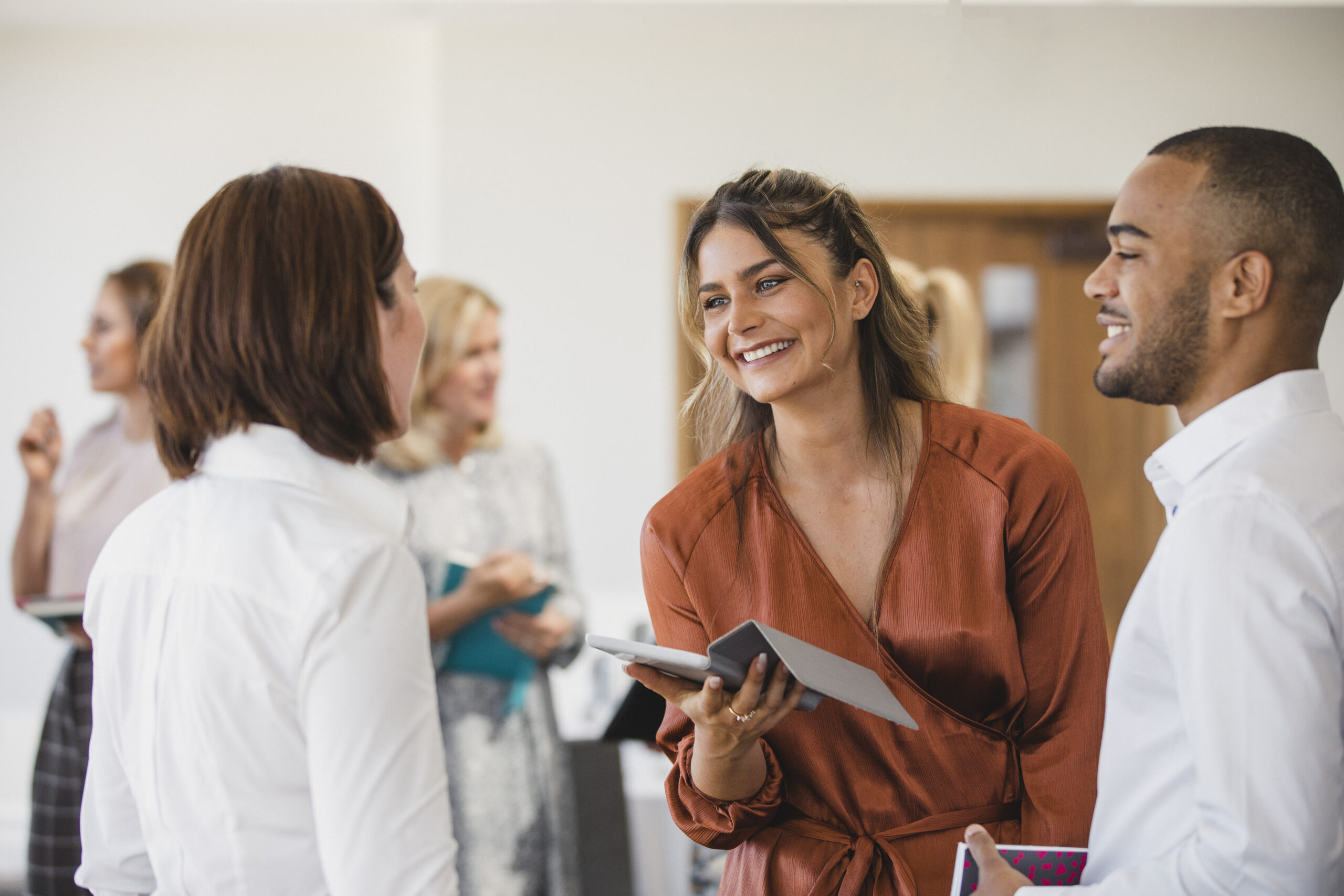 Young businesswoman smiling and listening, networking, collaboration, business conference