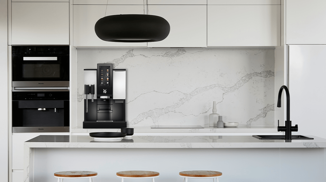 A white and marbled office setup featuring a WMF Commercial Coffee Machine