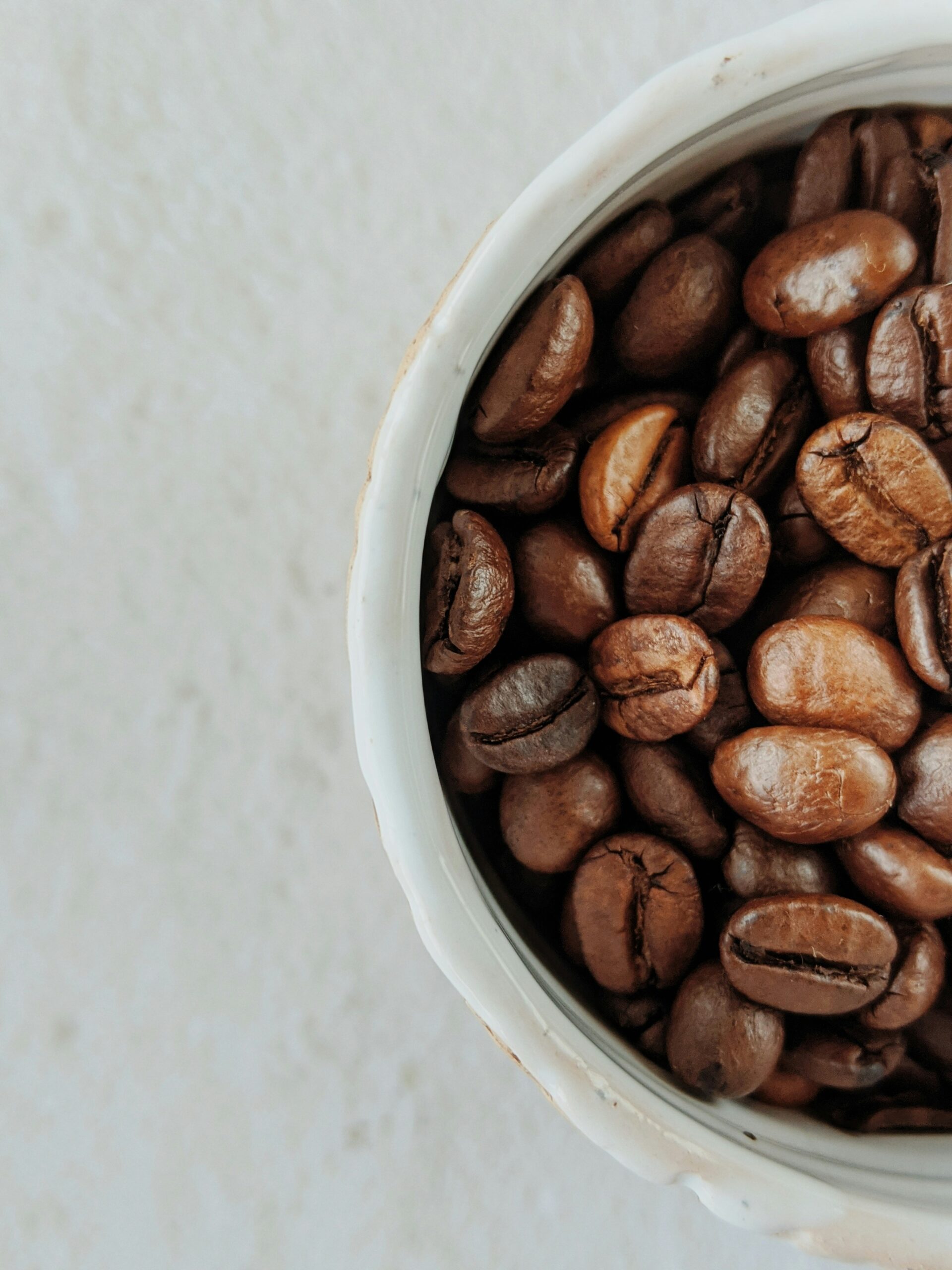 A cut off side image of a cup of coffee beans roasted