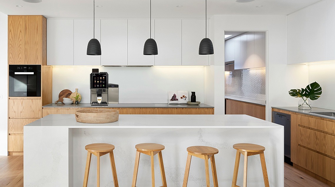 A white office setup featuring a Coffetek Commercial Coffee Machine